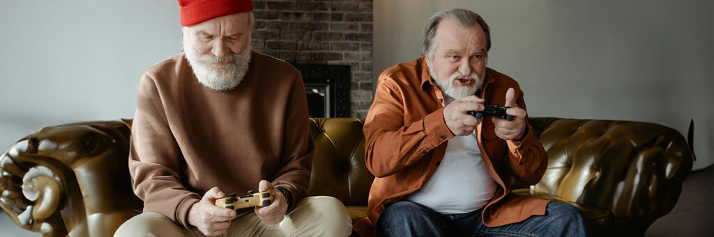 Two elderly gentleman playing video games